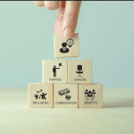 Small blocks with images of benefits written on them being stacked up to show non-monetary rewards for finance professionals